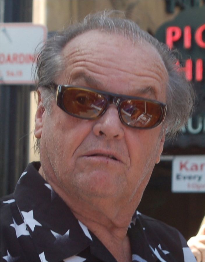 A cropped image of Jack Nicholson signing autographs