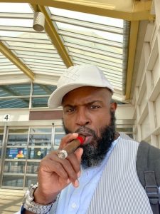 Yahya McClain smoking a cigar