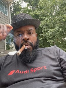 Boxing world champion, Yahya McClain enjoying a cigar outside