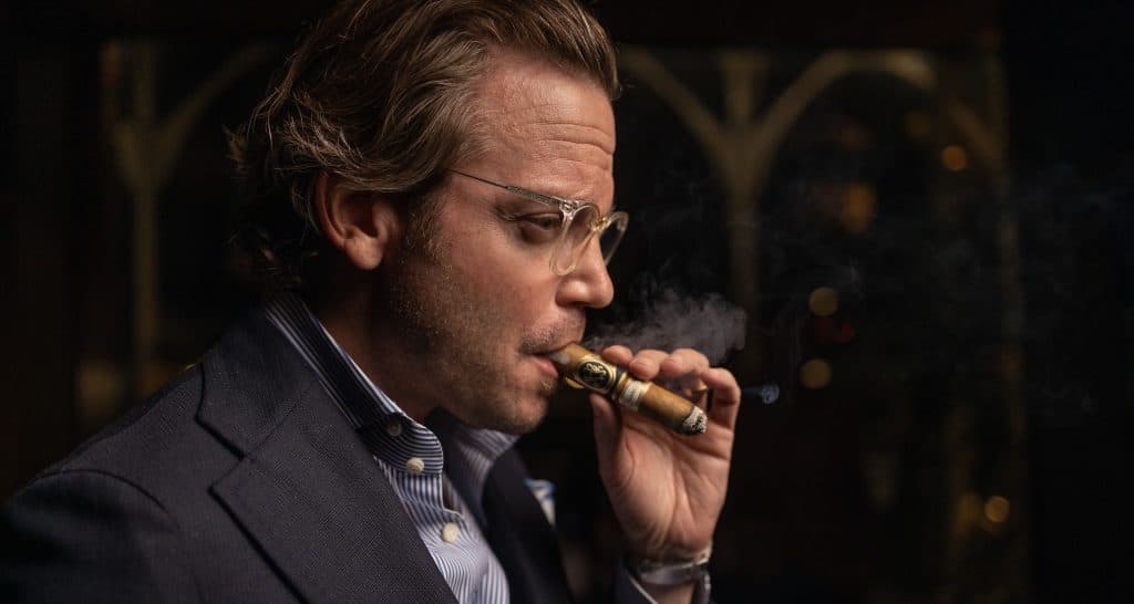 Michael Herklots smoking a cigar